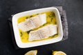 Steamed cod fillet butter-lemon sauce with herbs in the oven. Top view. In a baking dish. Healthy eating,