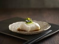 Steamed Cod Fish with Supreme Soya Sauce served in a dish isolated on wooden board side view dark background