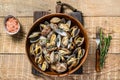 Steamed cooked shells Clams vongole in a wooden plate. wooden background. Top view