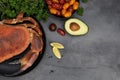 Steamed crab and fresh vegetables on dark background. Sea food dinner concept. Top view. Royalty Free Stock Photo