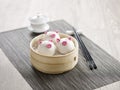 Steamed Custard Bun with Pine Seeds in Piggy Shape served in a wooden bowl with chopsticks isolated on mat side view on grey Royalty Free Stock Photo