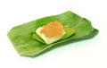 Steamed custard. Yellow Thai custard topping on sweet white sticky rice on green banana leaves package Royalty Free Stock Photo
