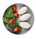 Steamed cutlets of three kinds of white meat with fresh spinach and tomatoes. Top view