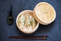 Steamed dumplings in bamboo steamer with chopsticks and soy sauce Royalty Free Stock Photo