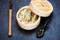 Steamed dumplings in bamboo steamer with chopsticks and soy sauce Royalty Free Stock Photo