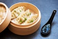 Steamed dumplings in bamboo steamer with soy sauce Royalty Free Stock Photo