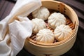 steamed dumplings in a wicker hamper with a linen napkin