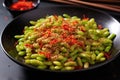steamed edamame beans sprinkled with chili flakes