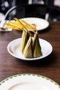 Steamed flour with coconut filling. Thai dessert wraps with banana leaves. Authentic and classic product design