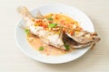 Steamed grouper fish with lime and chillies Royalty Free Stock Photo