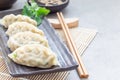 Steamed Korean dumplings Mandu with chicken meat and vegetables on black plate, horizontal, copy space Royalty Free Stock Photo