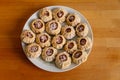 Steamed national Mongolian food dumpling Buuz filled with minced beef, white plate, wooden table, Close up east Siberian Buryats