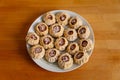 Steamed national Mongolian food dumpling Buuz filled with minced beef, white plate, wooden table, Close up east Siberian Buryats