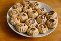 Steamed national Mongolian food dumpling Buuz filled with minced beef, white plate, wooden table, Close up east Siberian Buryats