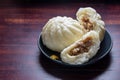 Steamed pork bun Nikuman, Chinese baozi on plate over wooden background, traditional Japanese food Royalty Free Stock Photo