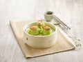 Steamed Prawn Dumpling with Abalone served in a wooden bowl with chopsticks isolated on mat side view on grey marble background Royalty Free Stock Photo