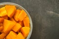 Steamed pumpkin in a glass bucket on dark background. Healthy carbohydrates Royalty Free Stock Photo