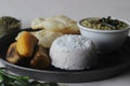 Steamed rice cake served with steamed plantain, green gram curry and papad. A favorite dish of Kerala commonly known as puttu with