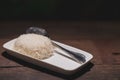 Steamed rice and a spoon in a white dish is placed on a wooden table. Royalty Free Stock Photo