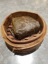 Steamed rice wrapped in teak leaves in a round wooden container Royalty Free Stock Photo
