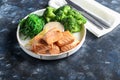 Steamed salmon with broccoli and seaweed salad. Diet healthy eating. On a dark background Royalty Free Stock Photo