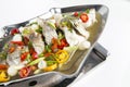 Steamed sea bass fish with pickled garlic and lime