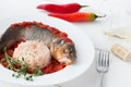 Steamed sea bass in tomato sauce with chili pepper. Royalty Free Stock Photo