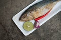 Steamed short mackerel served with red onion, lemon and red chili in foam tray