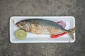 Steamed short mackerel served with red onion, lemon and red chili in foam tray