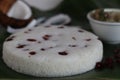 Steamed spongy rice cake topped with dried cranberries. Served with chicken stew