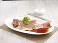 Steamed Star Grouper with Supreme Soya Sauce Served in a dish isolated on wooden board side view on grey background Royalty Free Stock Photo