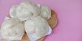 Steamed stuff bun on pink background. Royalty Free Stock Photo