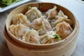 Steaming basket of Xiaolongbao, Chinese soup dumplings, in a traditional bamboo steamer