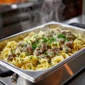 Steaming beef stroganoff pasta garnished with parsley in a pan. Royalty Free Stock Photo