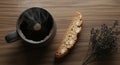 Steaming black coffee in a charcoal ceramic mug with almond biscotti flat lay on rustic wood Royalty Free Stock Photo