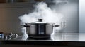 Steaming and boiling pan of water on modern heating stove in kitchen on the background of open balcony. Boiling with steam emitted Royalty Free Stock Photo