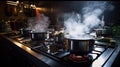Steaming and boiling pan of water on modern heating stove in kitchen on the background of open balcony Royalty Free Stock Photo