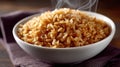 Steaming bowl of brown rice on a dark cloth surface. Royalty Free Stock Photo