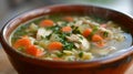 A steaming bowl of chicken noodle soup, brimming with tender chicken, veggies, and comforting broth. Royalty Free Stock Photo