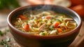 A steaming bowl of chicken noodle soup, brimming with tender chicken, veggies, and comforting broth. Royalty Free Stock Photo