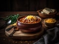 A steaming bowl of chili topped with shredded cheddar cheese