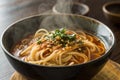 A bowl of steaming noodles with sauce and herbs, Asian cuisine Royalty Free Stock Photo