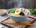A steaming bowl of ramen noodles topped with slices of tender pork belly, soft-boiled egg