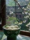 A steaming bowl of sliced winter melon tofu soup sits atop a bright kitchen dining bar