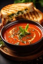 A steaming bowl of tomato soup with a grilled cheese sandwich on the side, Royalty Free Stock Photo