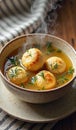 Steaming bowl of traditional matzo ball soup with fresh herbs Royalty Free Stock Photo