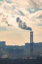 Steaming chimneys on a background of city houses