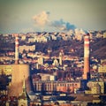 Steaming chimneys with houses in the city. Concept for environment and industry. Background with city landscape at sunset. Brno -