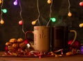 Steaming Christmas coffee cups bokeh lights decoration. Winter holidays music background, cozy home, love romance dating