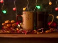 Steaming Christmas coffee cups bokeh lights decoration. Winter holidays music background, cozy home, love romance dating